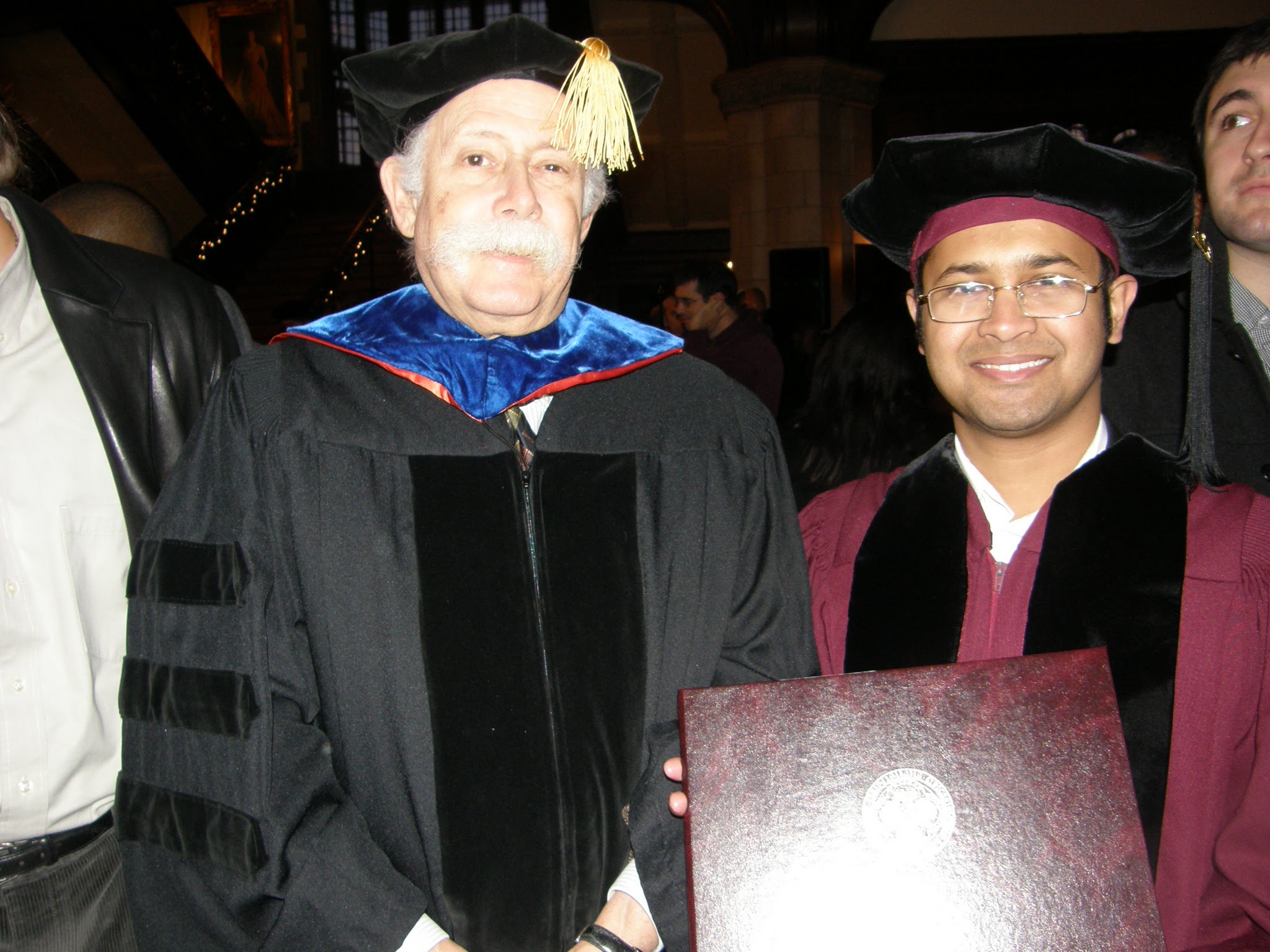 Dr. B stands with advisor at doctoral graduation ceremony
